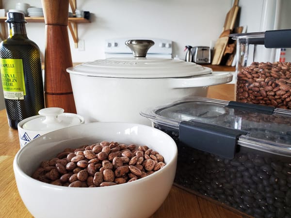 Beans in bowls and beans in bins, olive oil and cookie tins.